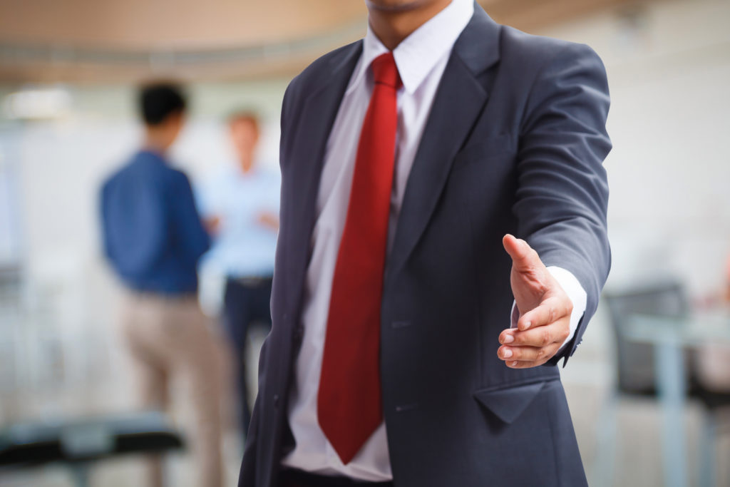 Businessman offering a handshake for welcome or deal concept